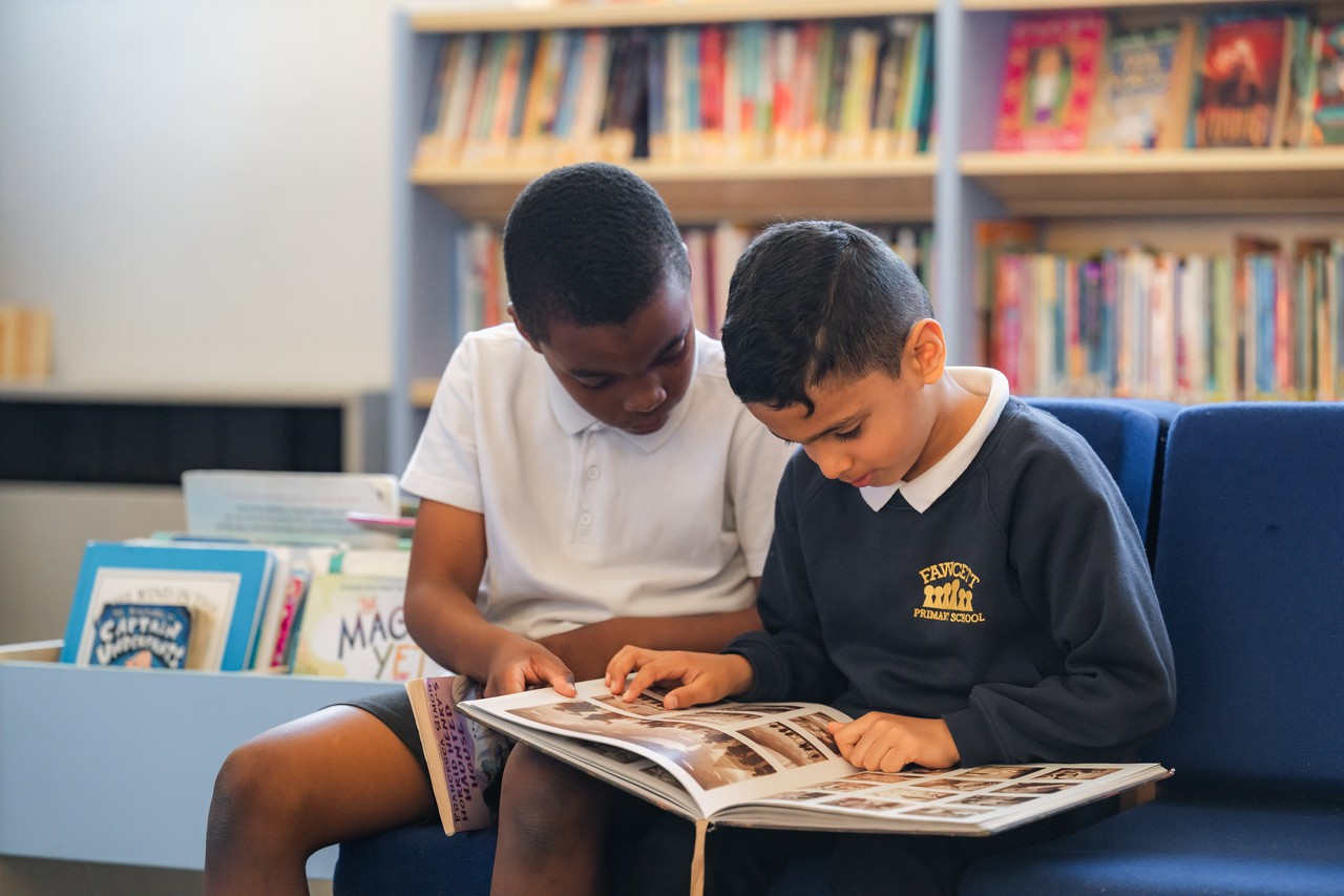 Children in a classroom touching a globe
