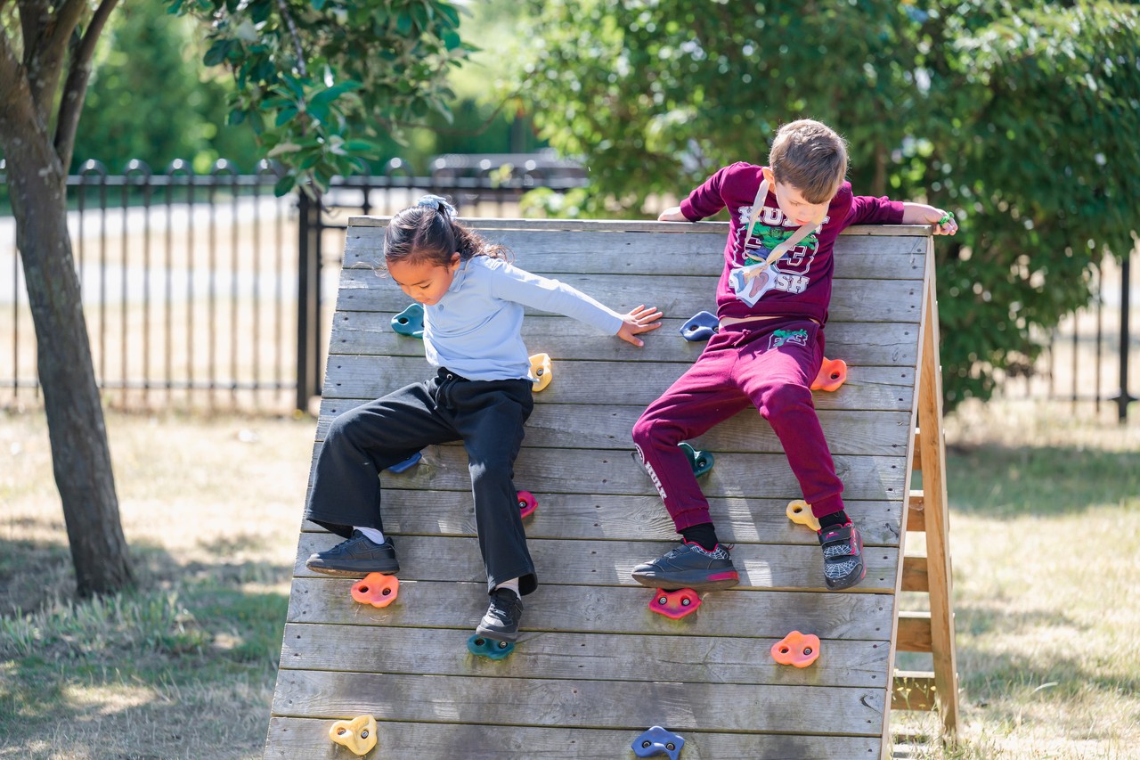 Two children on a small climbing wall